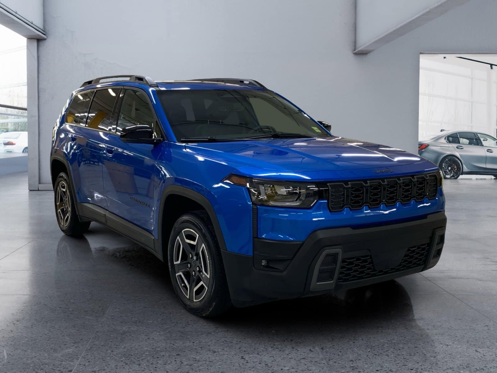 Blue SUV parked indoors, featuring a sleek design, modern grille, and tinted windows.