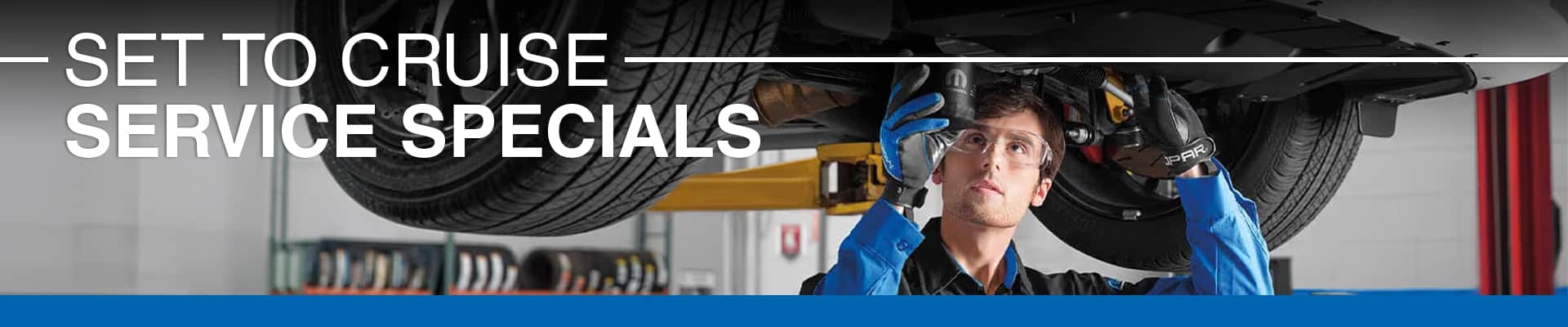 "Road Ready: Tires at Cost! Tire price match guarantee with confident mechanic and modern wheel."